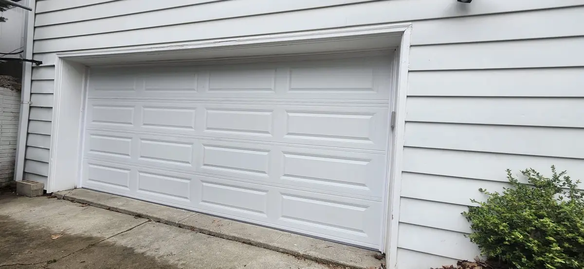 After: new white raised panel garage door on the same garage