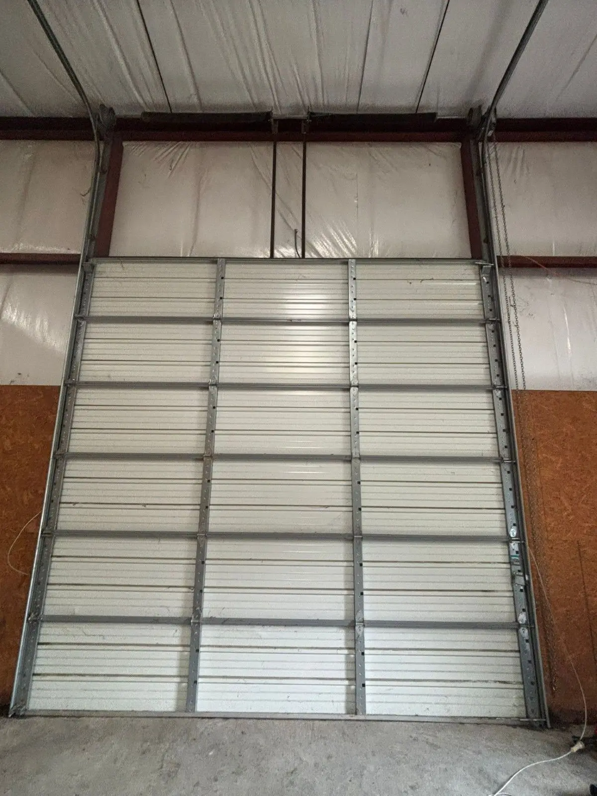 Tall sectional door inside a metal building
