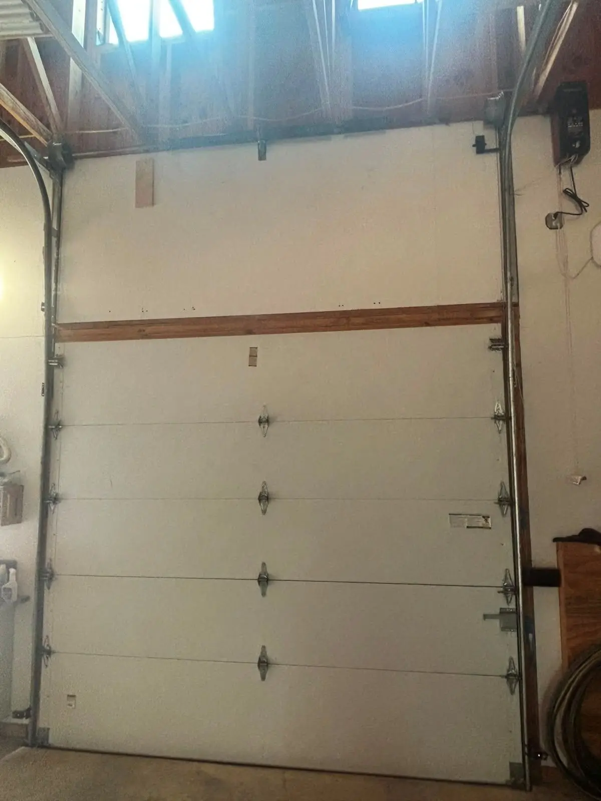 Tall sectional overhead door seen from inside a building