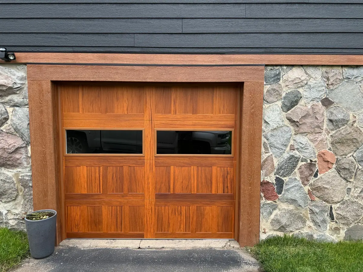 After: cedar tone carriage style garage door with windows in the same surround