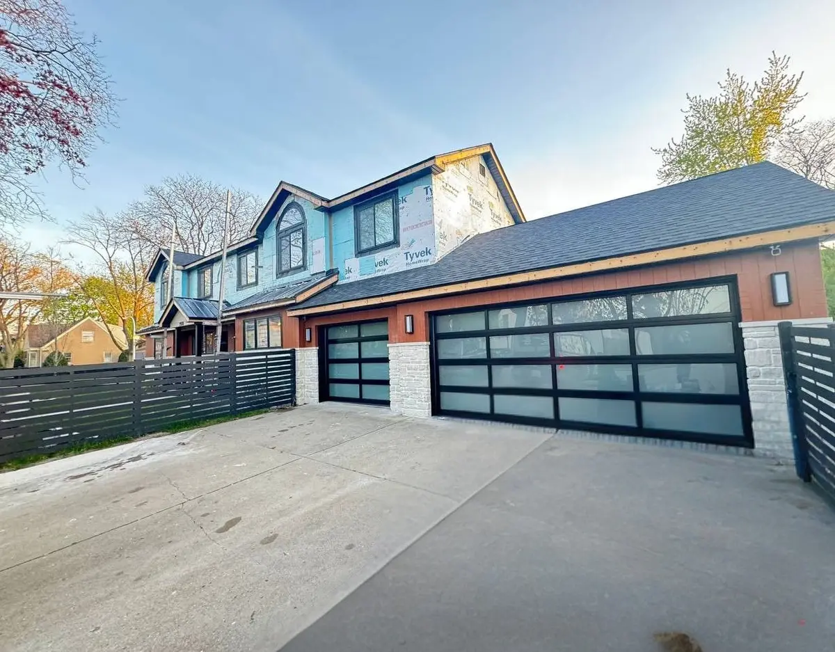 After: two black framed full view glass garage doors on the same home