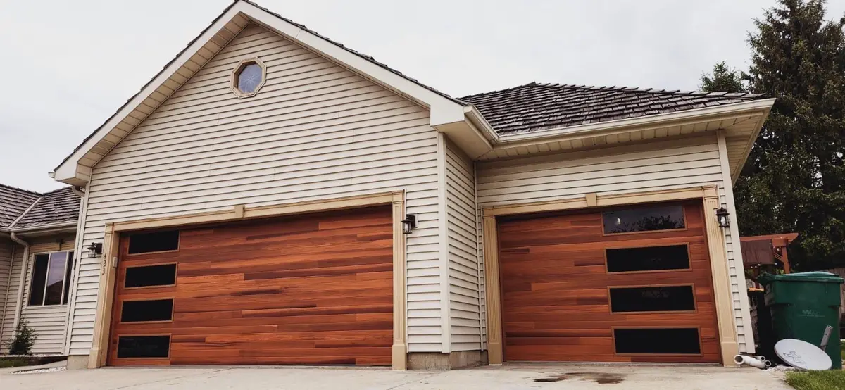 Two wood tone modern garage doors with black side windows