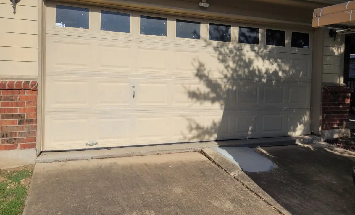 Before: almond double garage door with a row of windows