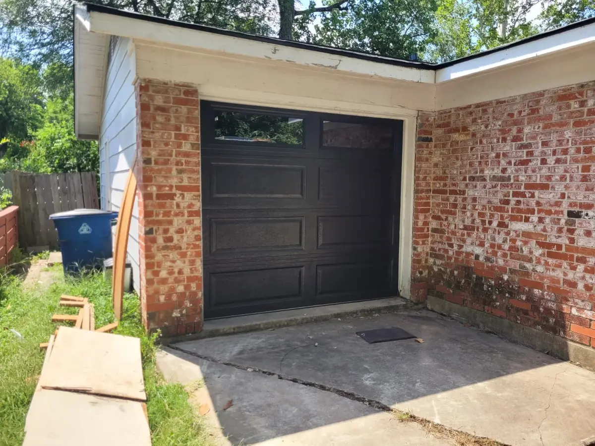 After: black long panel garage door with top windows installed by Tier One in Austin 78704