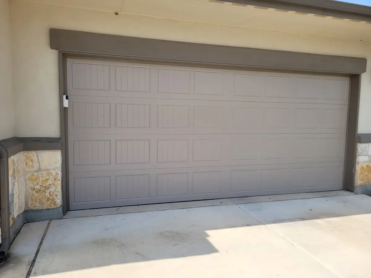Sandstone coloured double garage door installed by Tier One on a Hutto home