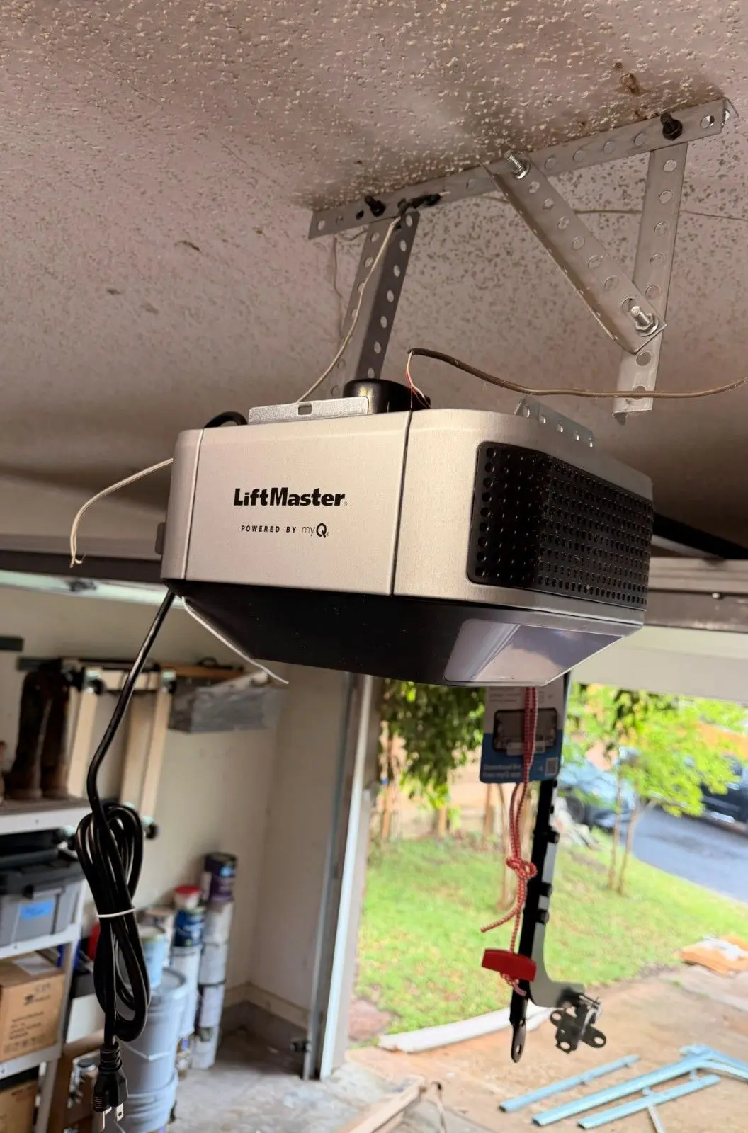 Newly installed LiftMaster garage door opener mounted to a garage ceiling