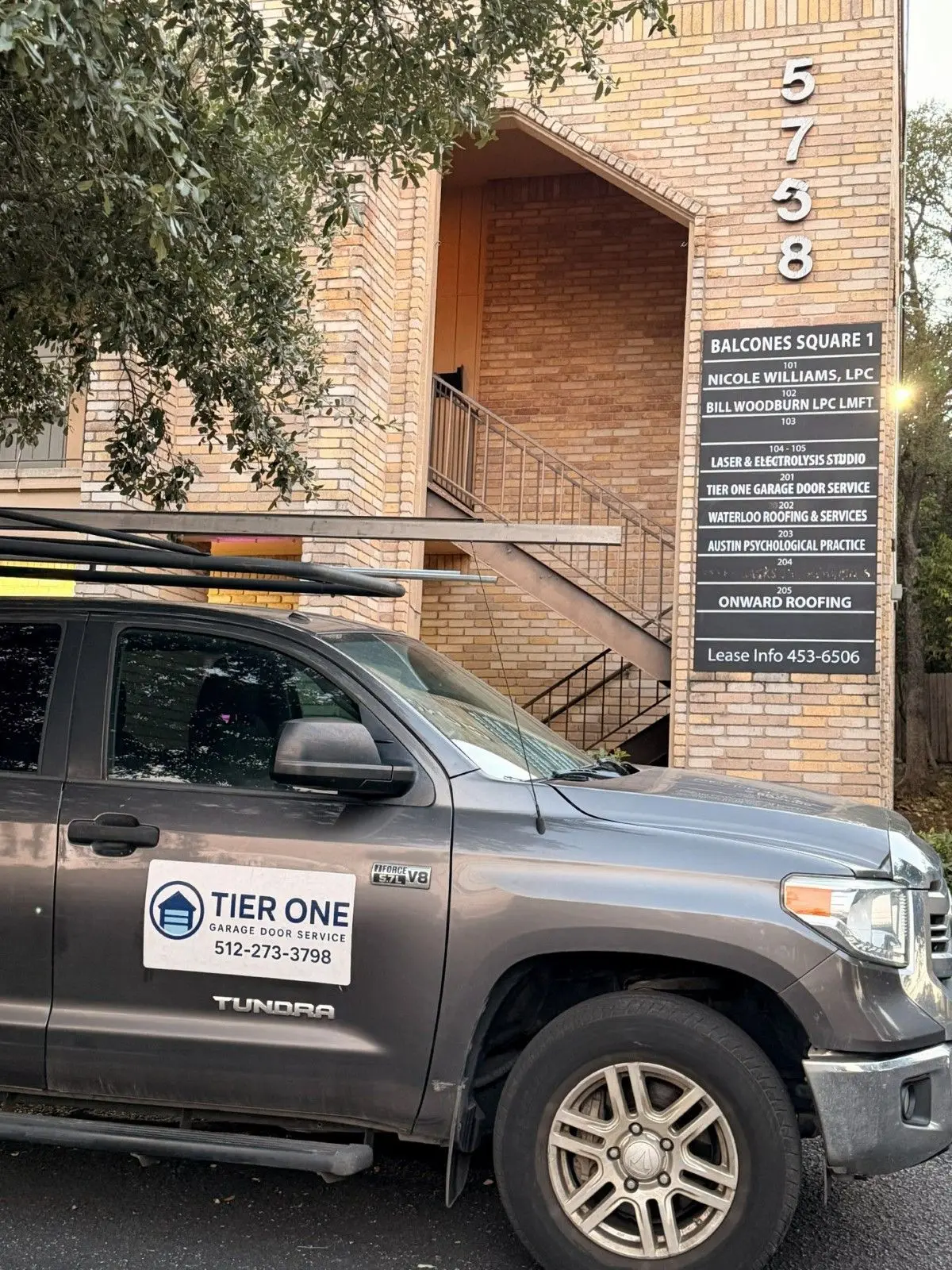 Tier One Garage Door Service truck parked outside the company office at 5758 Balcones Drive in Austin